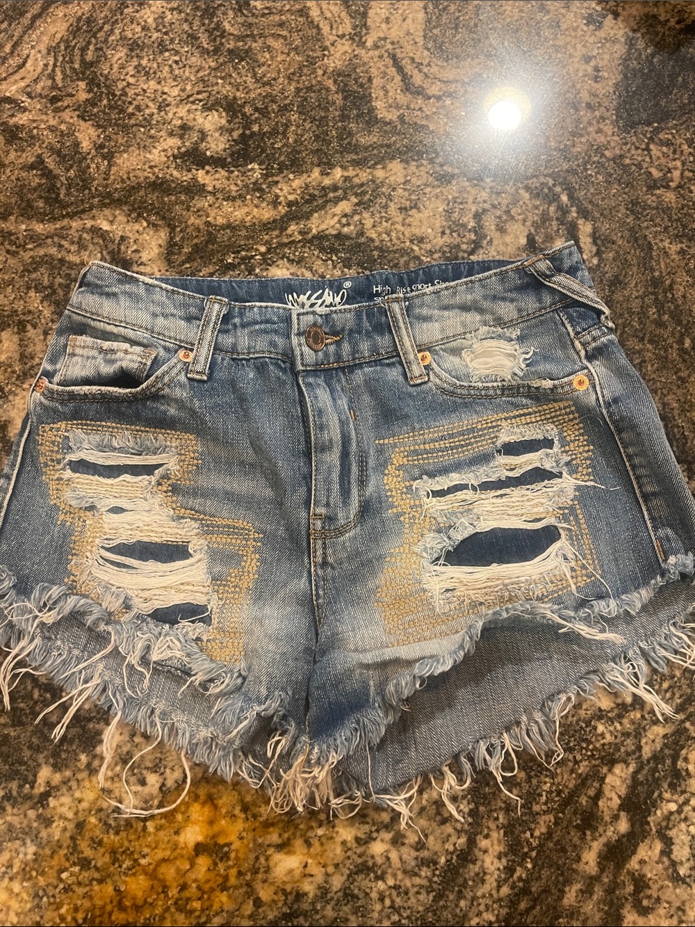 High-Rise Light Blue Distressed Jean Shorts with Frayed Hem